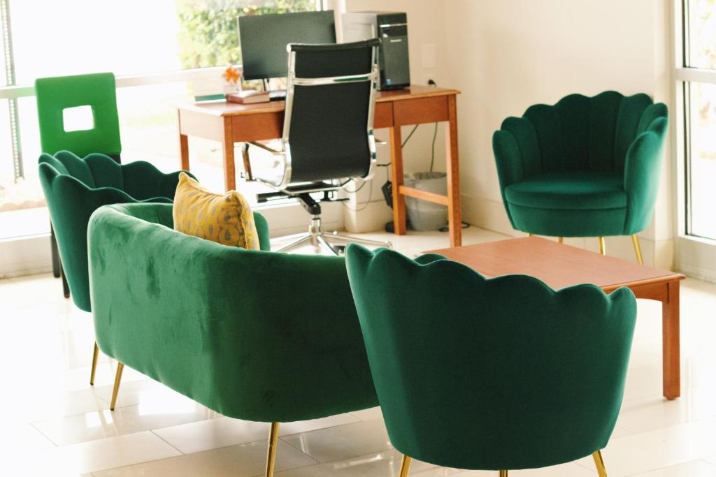 a waiting room with green chairs and a desk at Quality Inn near Chattanooga South in Ringgold