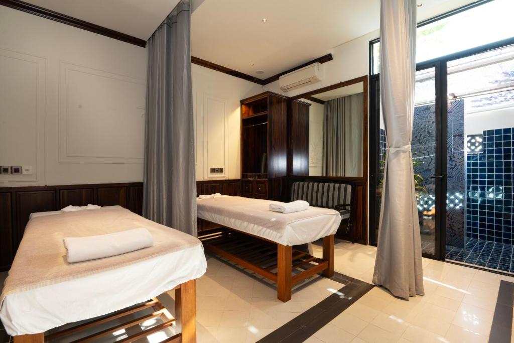 Giường trong phòng chung tại Maison Vy Hotel Hội An