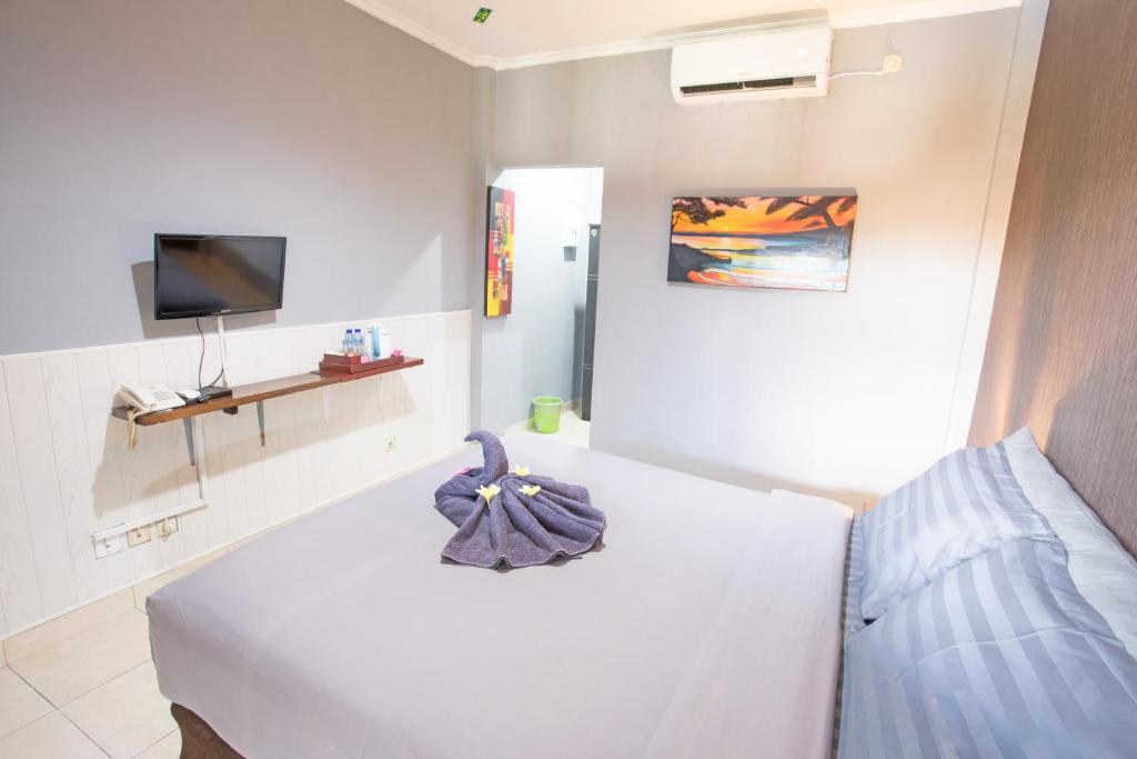 Postel nebo postele na pokoji v ubytování Jazz Senggigi Hotel