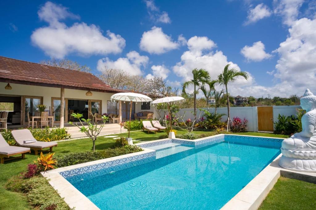 a swimming pool in the backyard of a house at Two Bedroom Luxury Villa in Nusa Dua in Nusa Dua