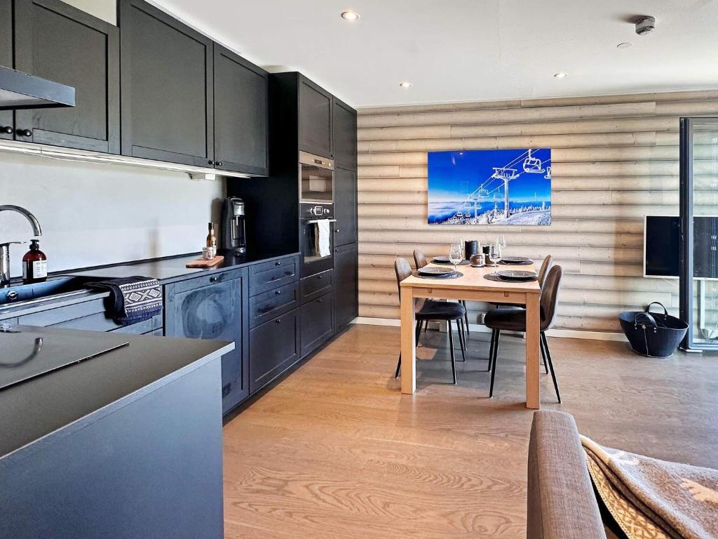 a kitchen with a table and chairs in a room at 4 person holiday home in GEILO-By Traum in Geilo