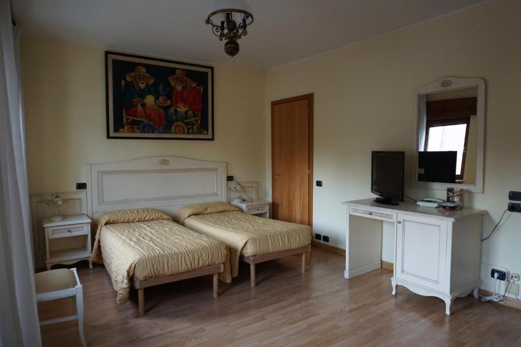 Postel nebo postele na pokoji v ubytování Hotel Siros