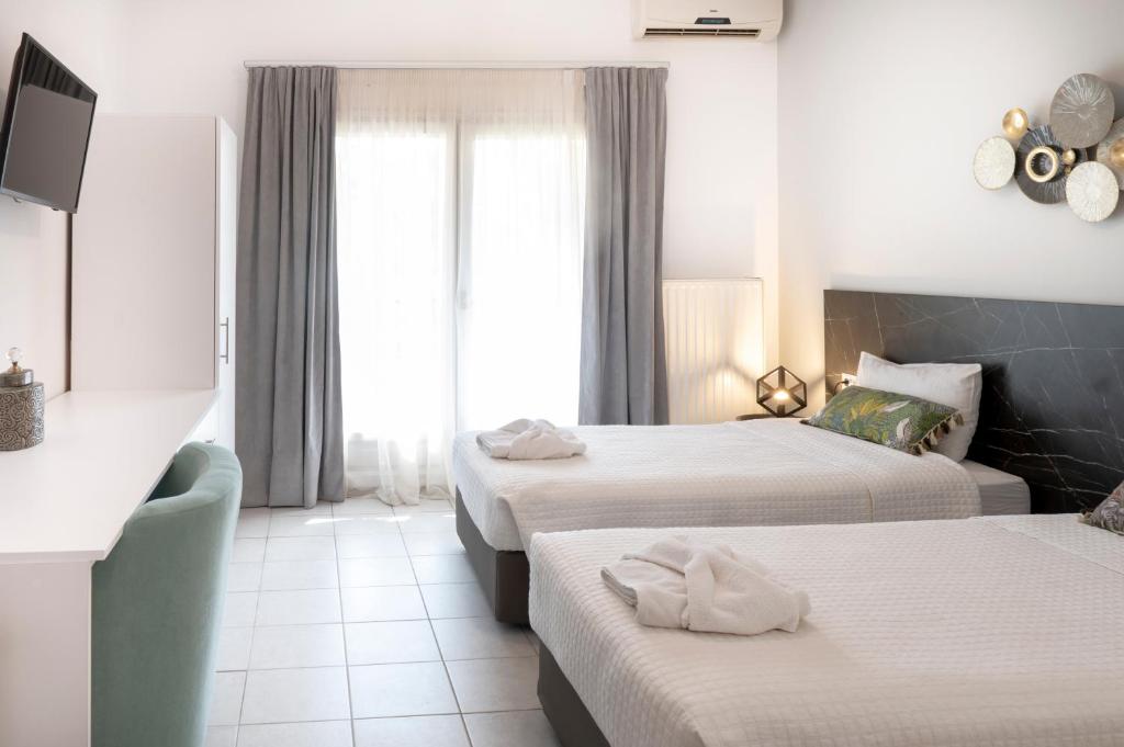 Postel nebo postele na pokoji v ubytování Hotel Papanikolaou