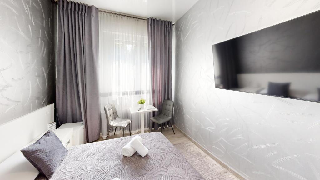 a bedroom with a bed and a table and chairs at B&B Luxury House Rho in Rho