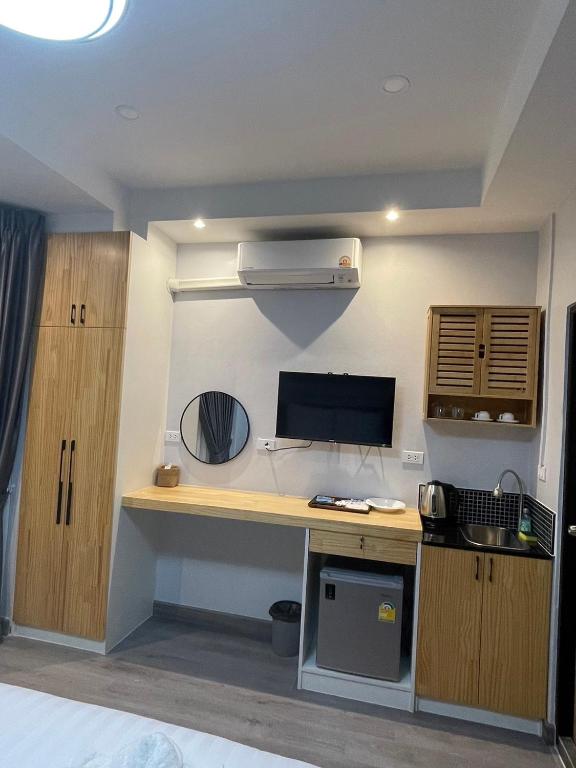 A built-in desk and refreshment station beneath the room television.