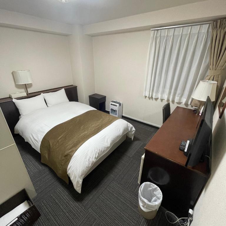 Postel nebo postele na pokoji v ubytování Takatsuki W and M Hotel
