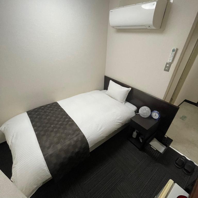 Postel nebo postele na pokoji v ubytování Takatsuki W and M Hotel