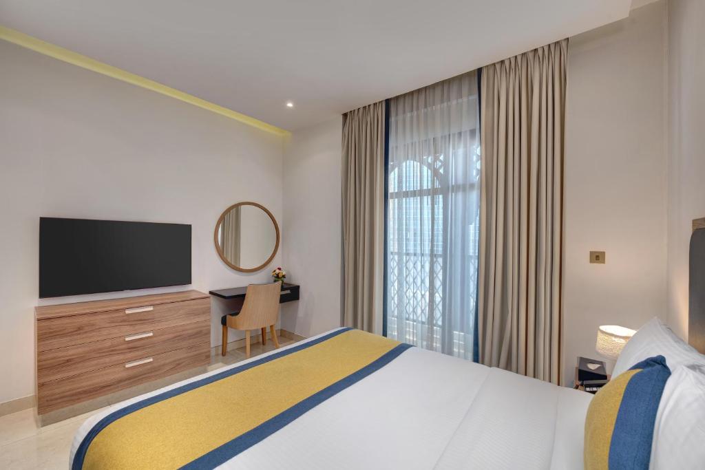 Postel nebo postele na pokoji v ubytování SUHA Park Hotel Apartments, Waterfront Jaddaf