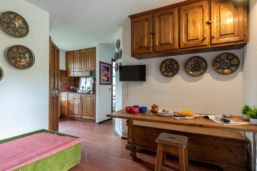 a kitchen with wooden cabinets and a counter top at Flat with Garden in Courmayeur - Happy Rentals in Courmayeur