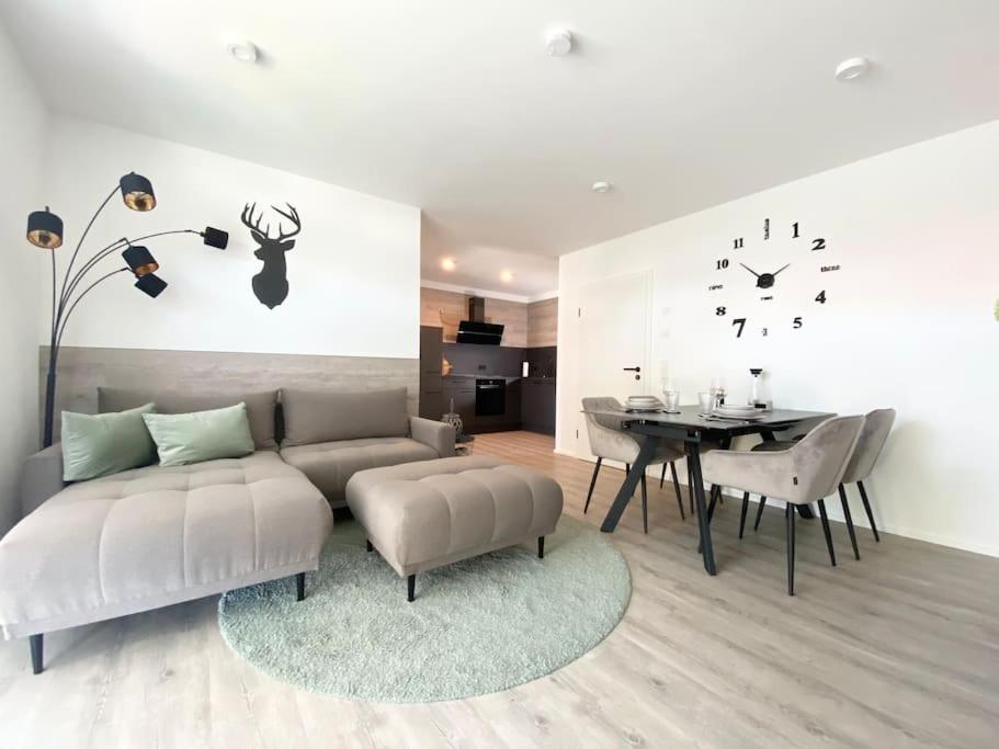 a living room with a couch and a table at Oh my Deer nagelneues Appartement für Zwei in Tauberbischofsheim