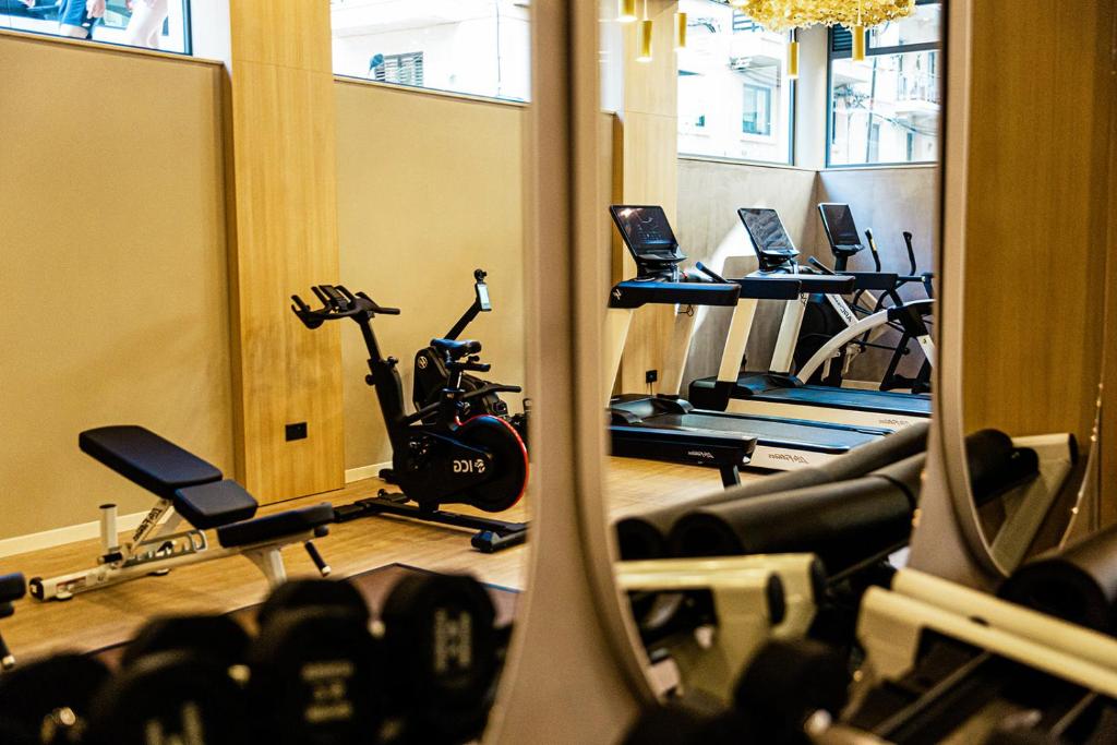 a gym with a row of treadmills and exercise bikes at 1926 Le Soleil Hotel & Spa in Sliema