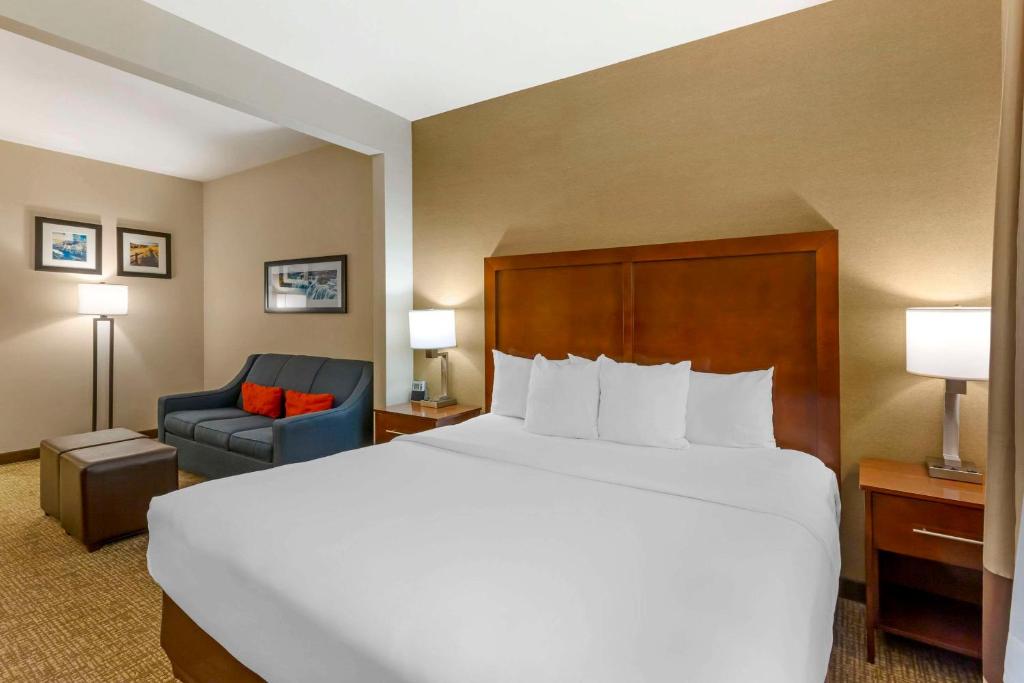 a hotel room with a large bed and a chair at Comfort Inn & Suites Jerome - Twin Falls in Jerome