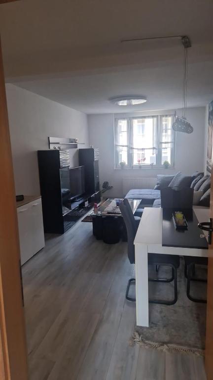 a living room with a couch and a table at Gemütliches Apartment in Altendorf