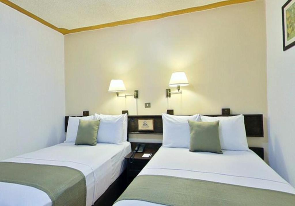 Postel nebo postele na pokoji v ubytování Hotel Misión Xalapa