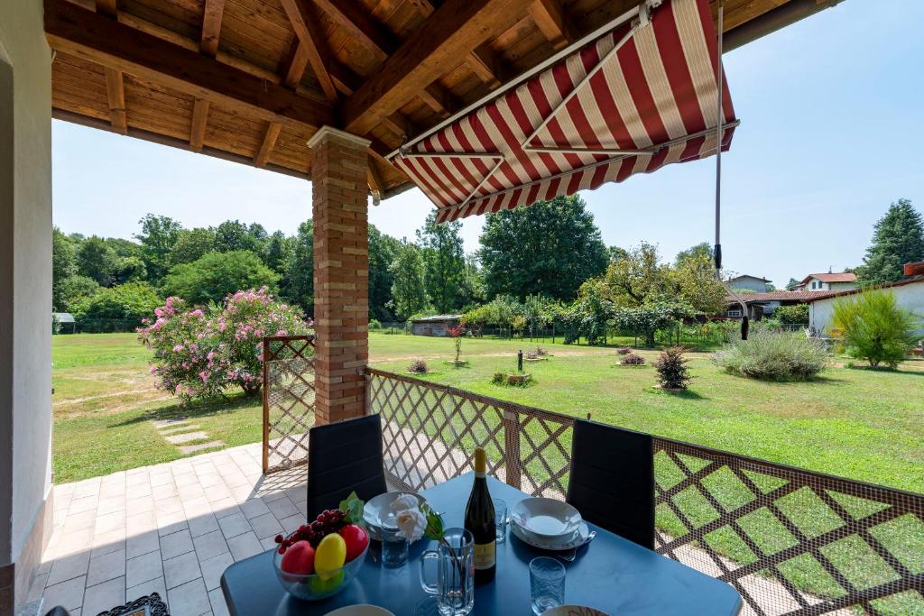 a patio with a table and an umbrella at La Casa In Campagna 800m from lake - Happy Rentals in Leggiuno