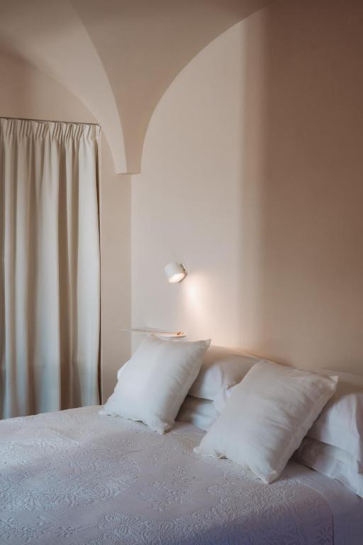 Postel nebo postele na pokoji v ubytování OZIO - Il trullo rosso
