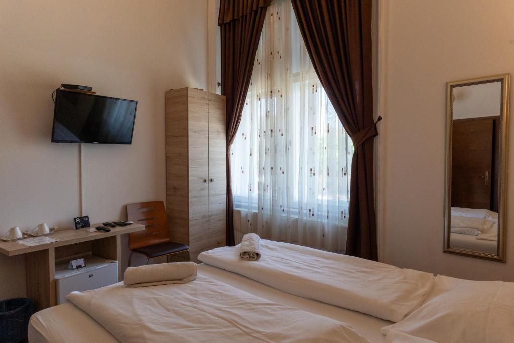 Posteľ alebo postele v izbe v ubytovaní Vinci Apartman