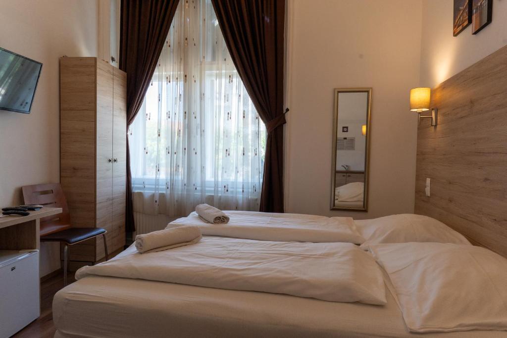 Posteľ alebo postele v izbe v ubytovaní Vinci Apartman