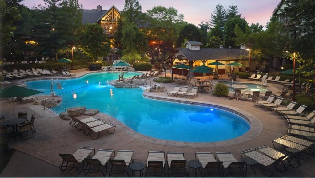 a large swimming pool with lounge chairs and tables at Marriott Willow Ridge 2BD sleeps 8 in Branson
