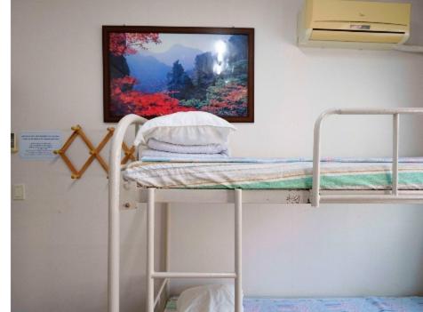 Postel nebo postele na pokoji v ubytování Hwaseong Guesthouse