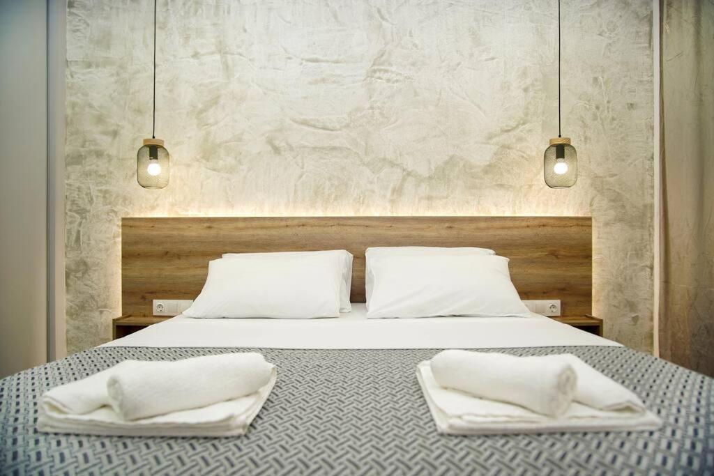 a bedroom with a bed with two white pillows at Urban Elegance Retreat VIPGreece in Athens