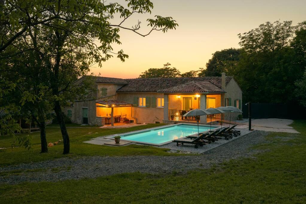 a house with a swimming pool in front of a house at Villa Dobrila by IstriaLux in Stari Pazin