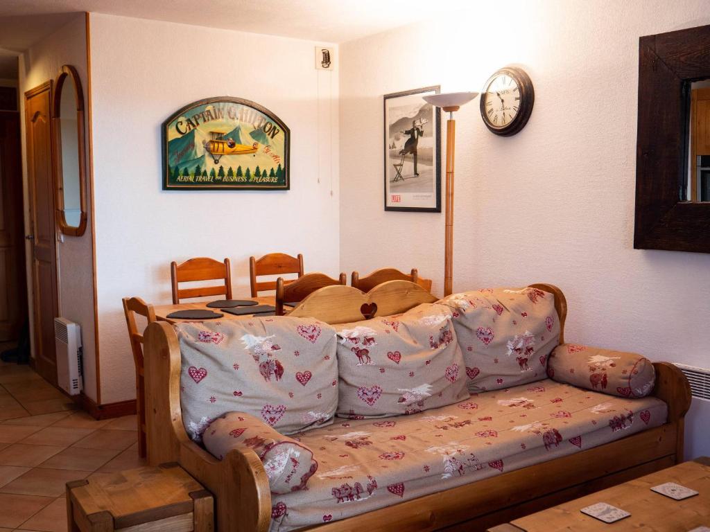 un salon avec un canapé et une horloge au mur dans l'établissement Charmant appartement 3 pièces à Méribel, proche pistes et commerces - FR-1-355-84, à Méribel