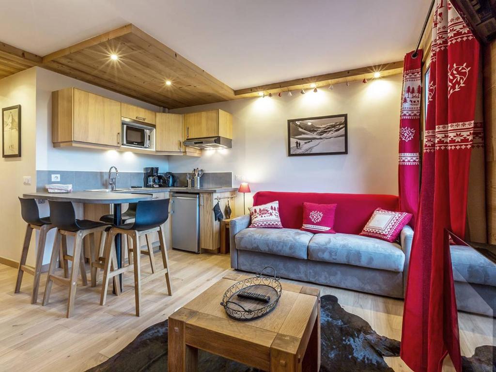 a living room with a couch and a table at Appartement rénové à Méribel, proche pistes, balcon, 4 couchages - FR-1-355-108 in Méribel