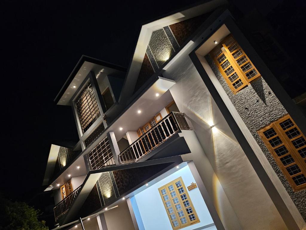 a night view of a building at night at MetroNova Homes - Furnished stay in Ambalappuzha in Alleppey