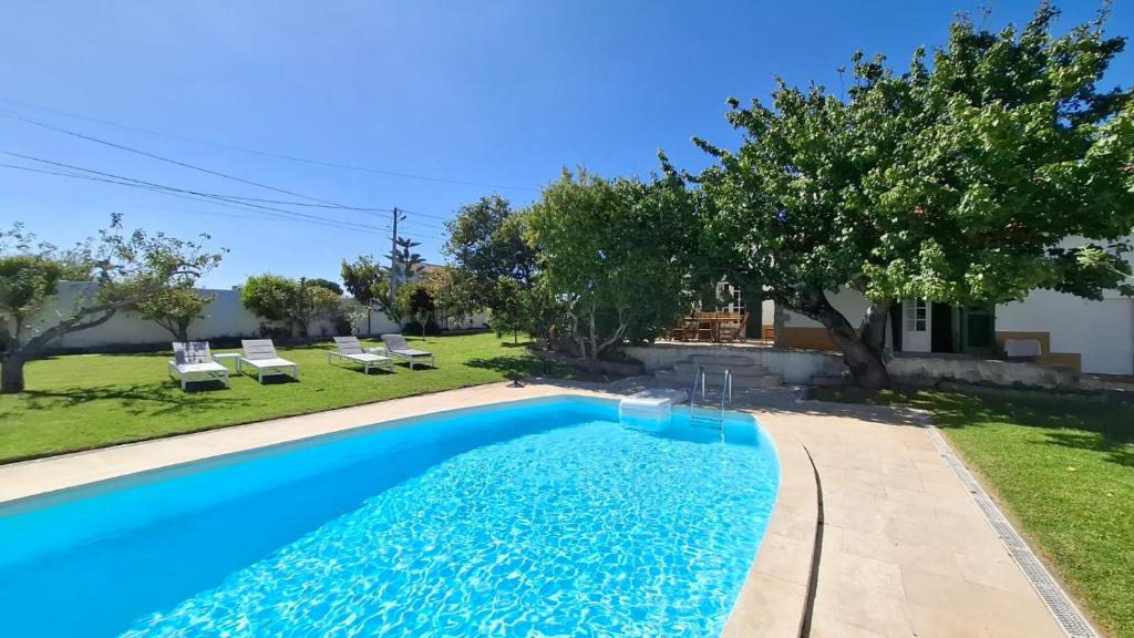 ein Swimmingpool in einem Hof mit einem Haus in der Unterkunft Casa do Patio - Très charmante villa 12 personnes 5ch avec piscine in São Bartolomeu