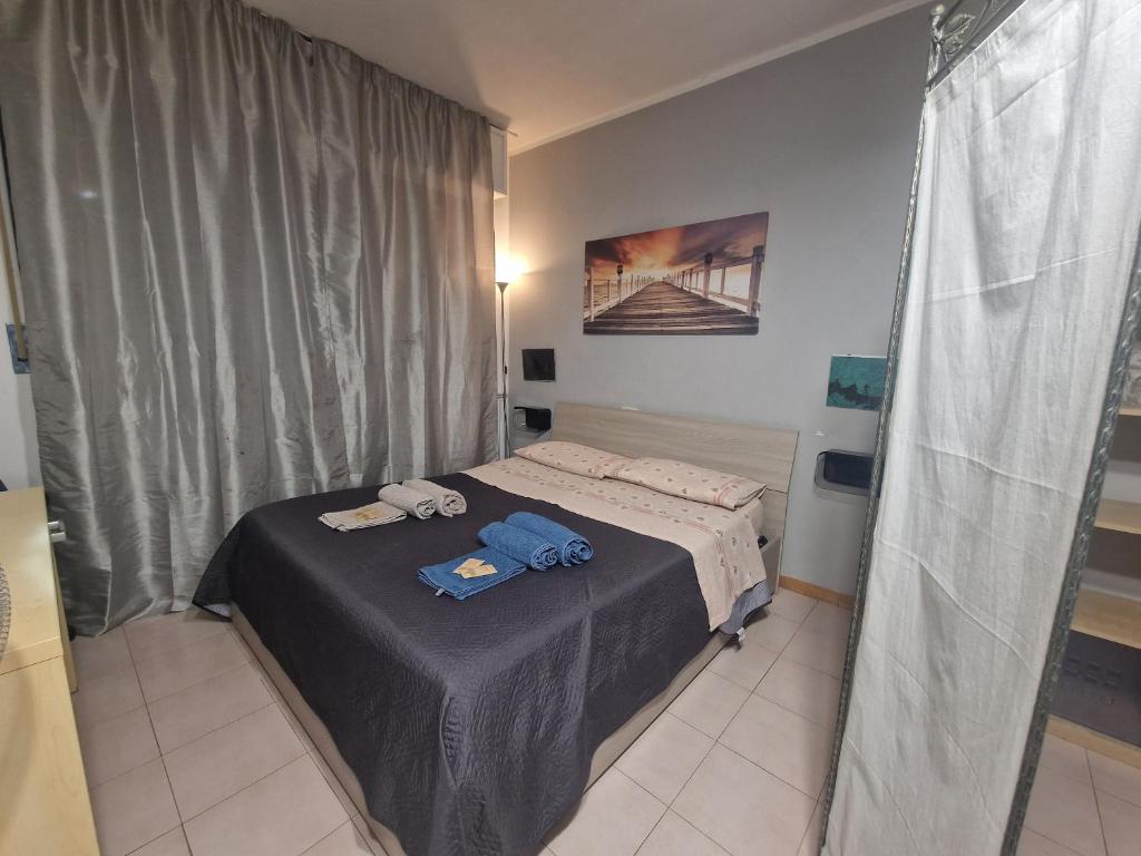 a small bedroom with a bed with towels on it at House 417 Perugia in Perugia