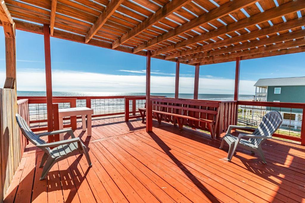 two chairs and a table on a deck with the ocean at Unobstructed Oceanfront SAND DOLLAR Unit 7 Beach Pad! in Surfside Beach