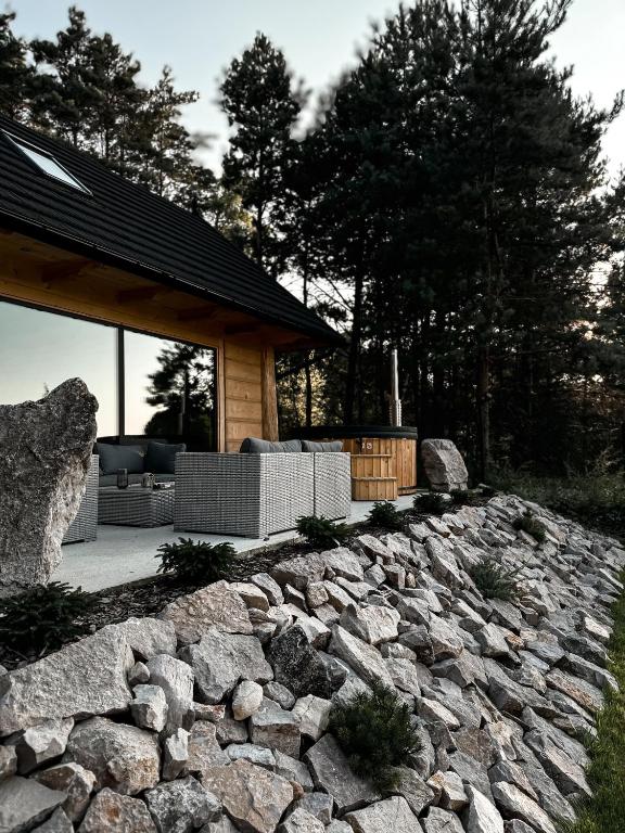 a stone retaining wall in front of a house at Domki Trzy Szczyty in Daleszyce