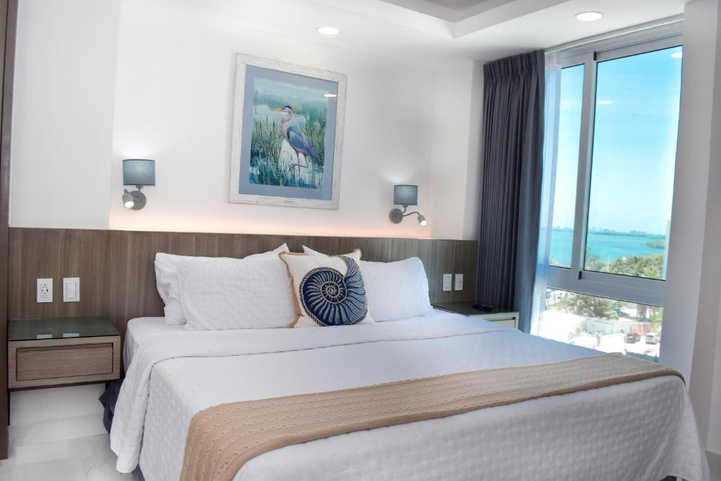 a bedroom with a large bed with a large window at New studio at the Beach, pool, gym, spa 2D in Cancún