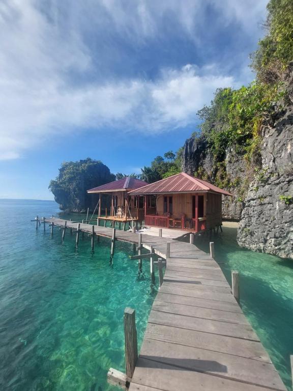 a house on a dock in the water at Nuttonton Homes in Papas