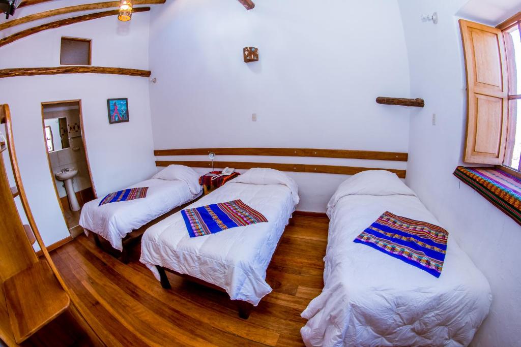 Postel nebo postele na pokoji v ubytování Hostal El Grial