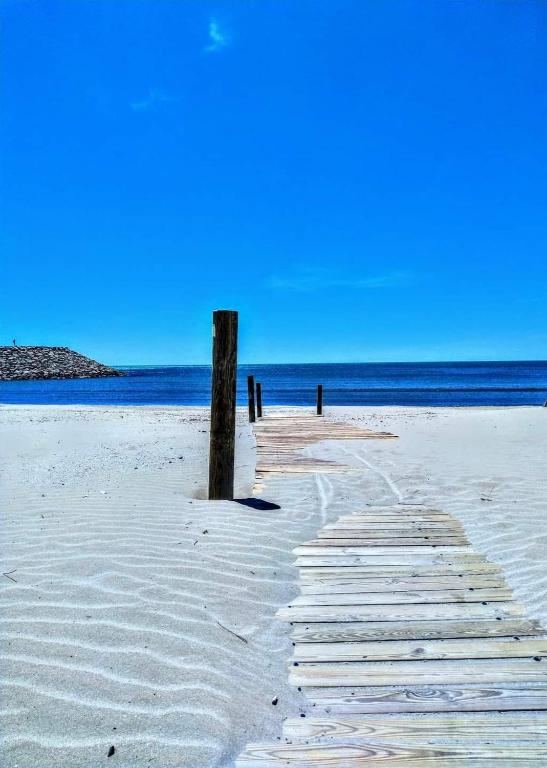 une promenade sur une plage avec l'océan en arrière-plan dans l'établissement Studio - La Grande Motte, à La Grande Motte
