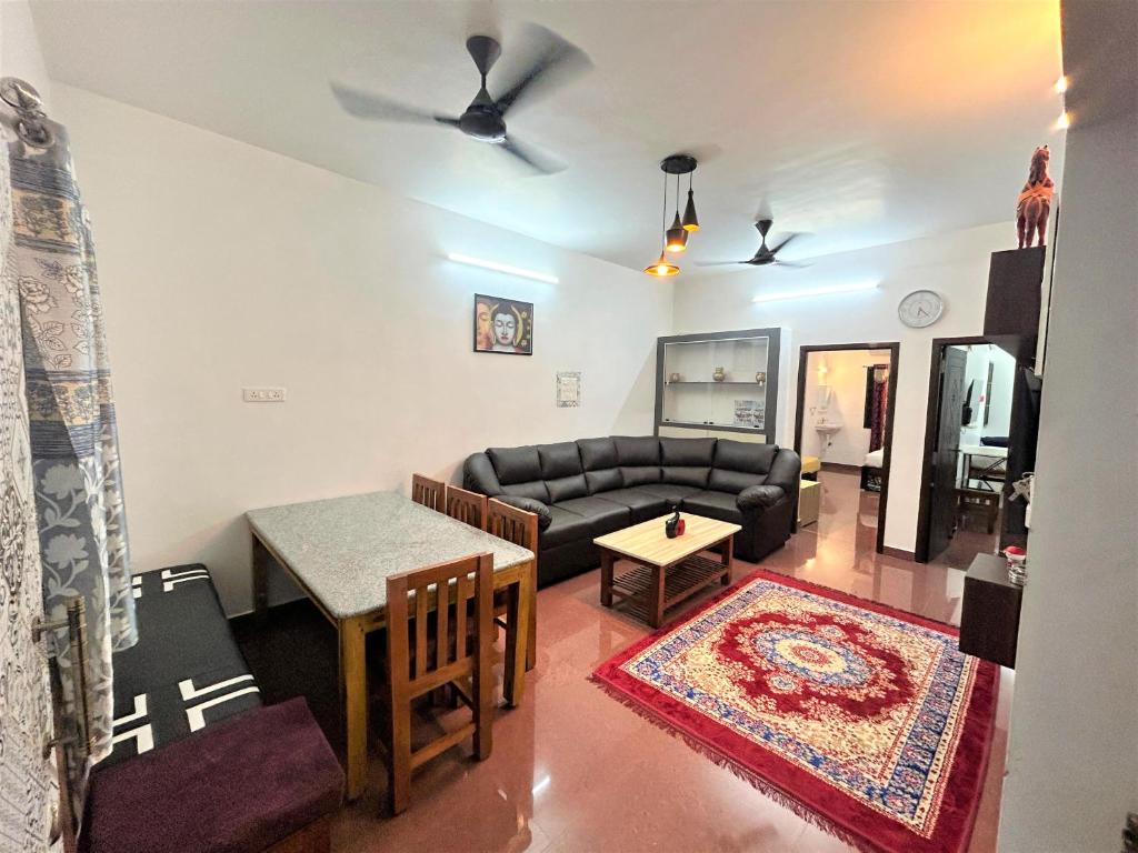 a living room with a couch and a table at Cardiff palace in Pondicherry