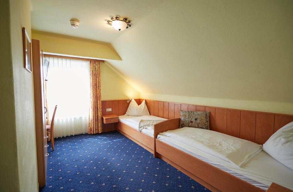 Postel nebo postele na pokoji v ubytování Hotel Gasthof Stenitzer