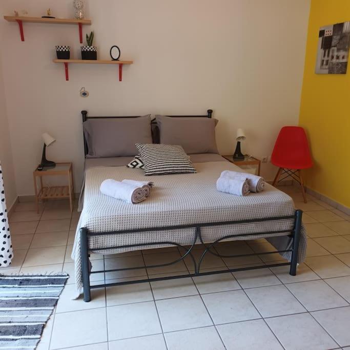 a bed in a room with two towels on it at Stelios apartment 1 in Chios
