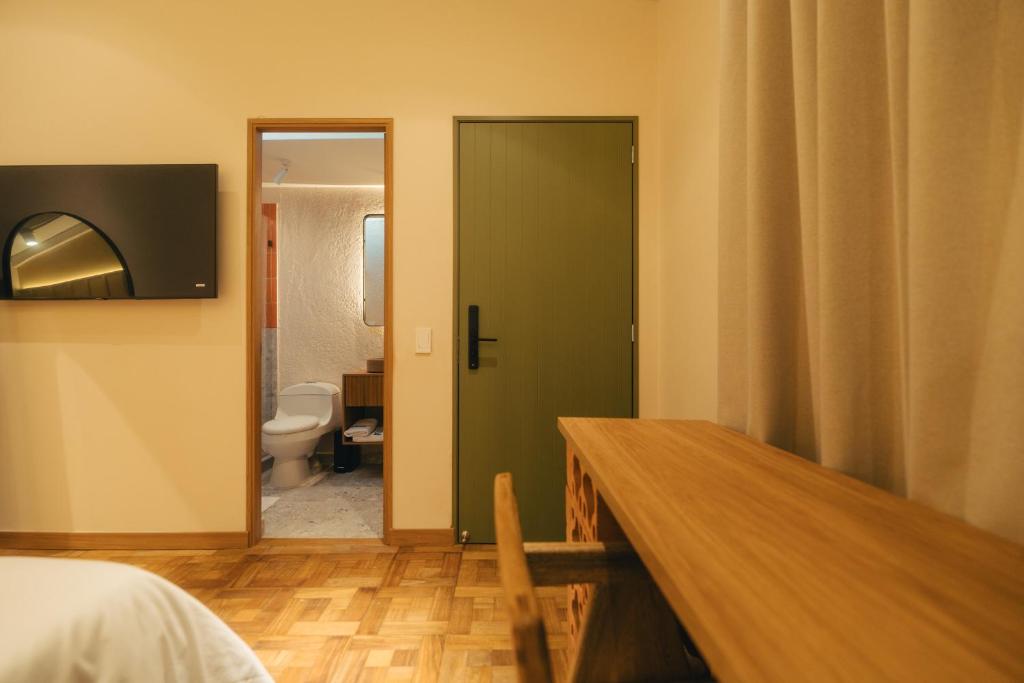 Postel nebo postele na pokoji v ubytování Hotel Boutique Roomzz Laureles
