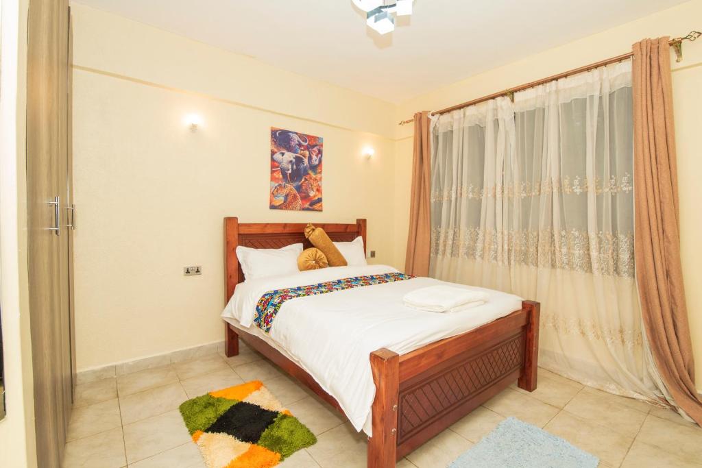 Postel nebo postele na pokoji v ubytování Chrismario Homes