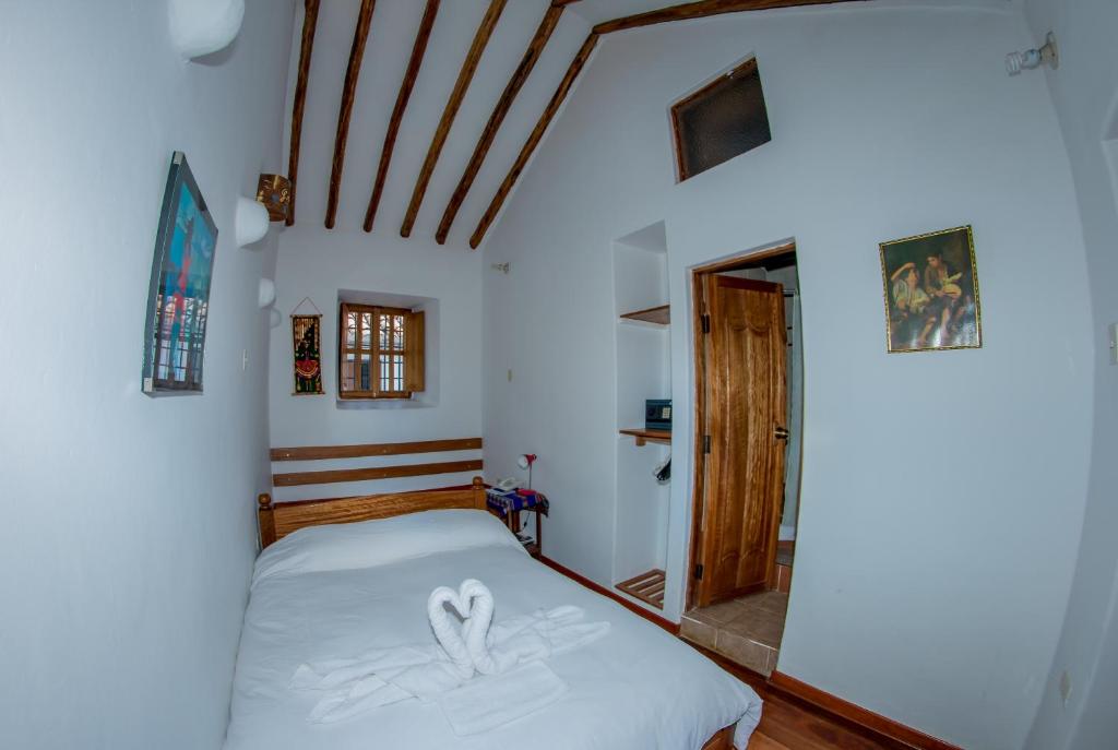 Postel nebo postele na pokoji v ubytování Hostal El Grial