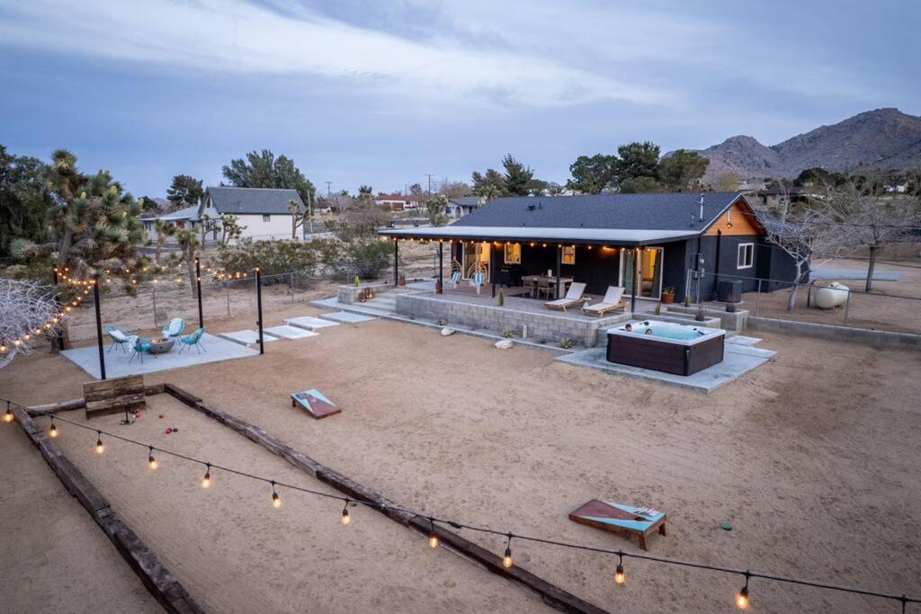 a house in the middle of a yard with lights at Soul Shine - Gorgeous Views - Modern - NEW in Joshua Tree