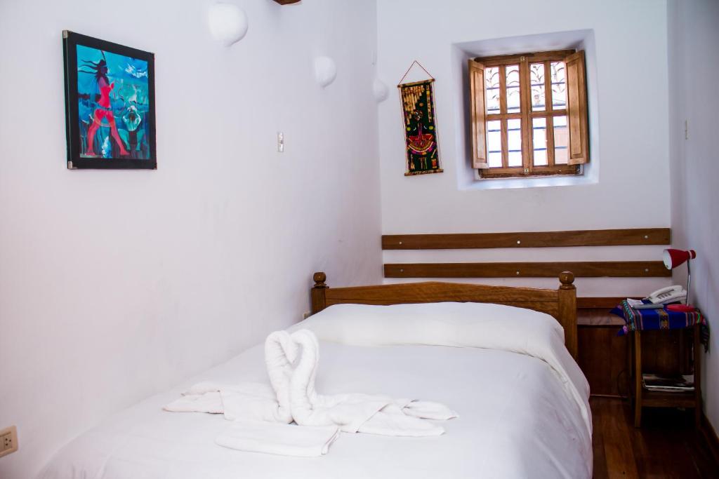 Postel nebo postele na pokoji v ubytování Hostal El Grial
