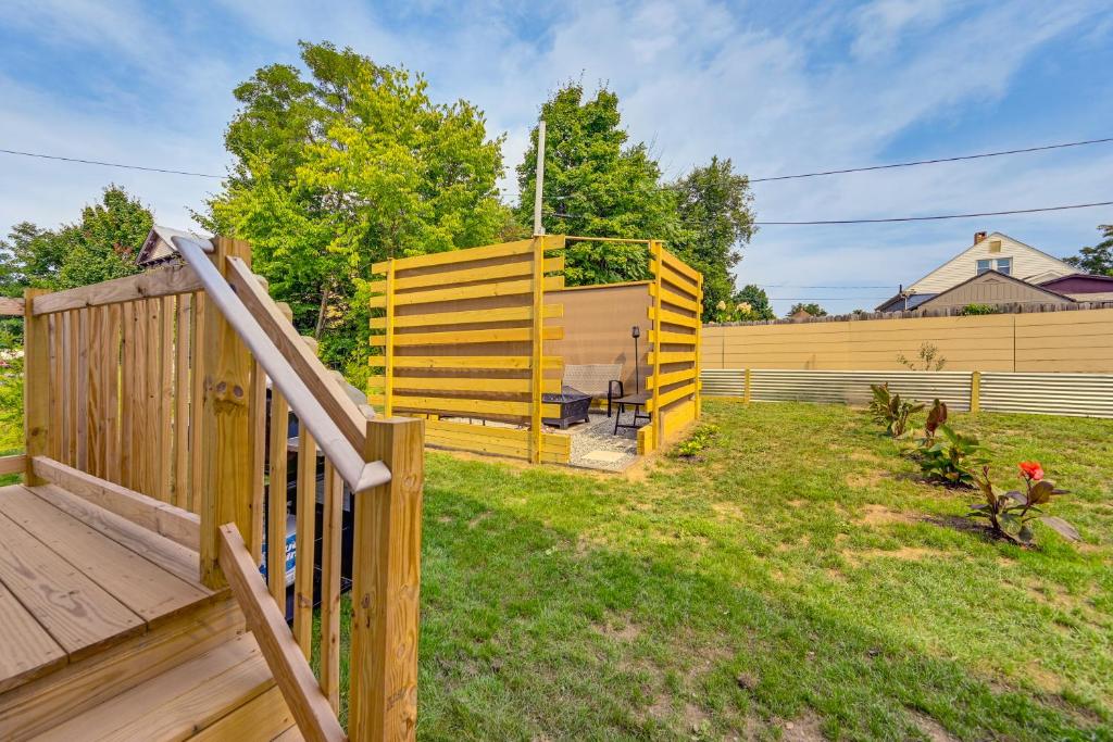 a backyard with a yellow fence and a deck at 1 Mi to MGM Springfield: Cozy Winter Duplex! in Springfield