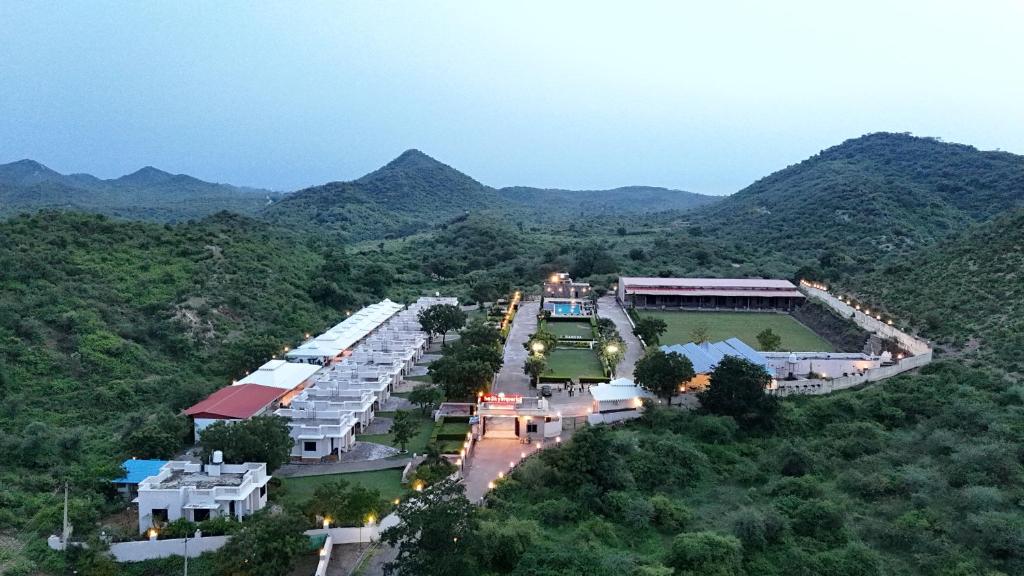 an aerial view of a resort with mountains in the background at The Sky Imperial Nakoda Green Valley Resort in Nāthdwāra