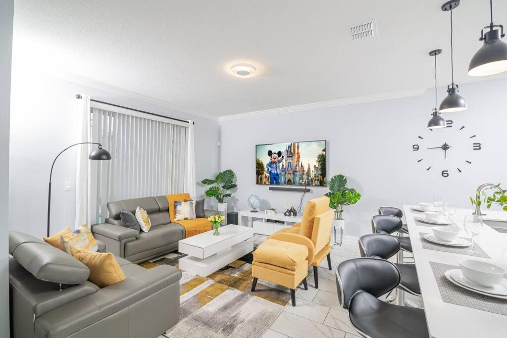 a living room with a table and a dining room at EPIC STYLISh retreat With Free water park near Disney in Kissimmee