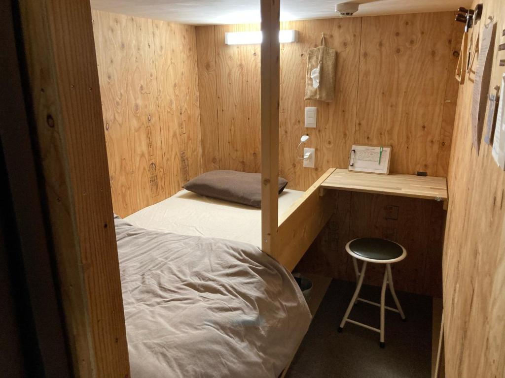 a bedroom with a bed and a desk and a stool at Choine Hotel Sapporo Teine - Vacation STAY 97420v in Sapporo