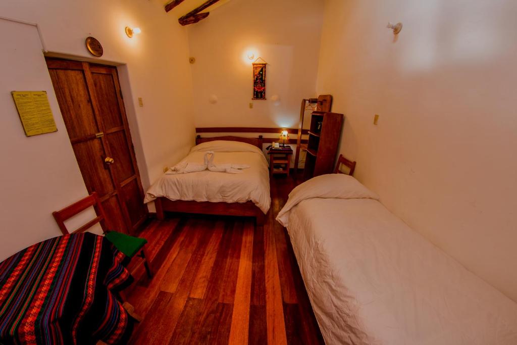 Postel nebo postele na pokoji v ubytování Hostal El Grial